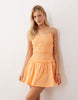 crinkle mini sundress with shirred dropped waist in orange spritz