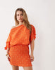Never Fully Dressed Petite Tilly off shoulder plisse mini dress in orange
