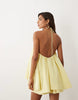halter neck trapeze mini dress in soft yellow