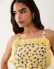 pinny mini dress with pockets and ruffles in yellow ditsy print