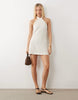 halter neck mini dress in cream