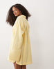 double cloth mini shirt dress with wide cuffs and oversized pockets in lemon