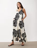 sleeveless v-neck trapeze maxi dress in black and cream leaf print