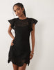 crochet flutter sleeve mini dress in black scuba-style fabric