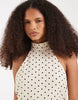 Vero Moda halter neck polka dot mini dress in cream and black