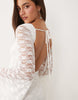 The Frolic exclusive boat neck open back frill sleeve & hem mini dress in white