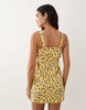 pinny mini dress with pockets and ruffles in yellow ditsy print